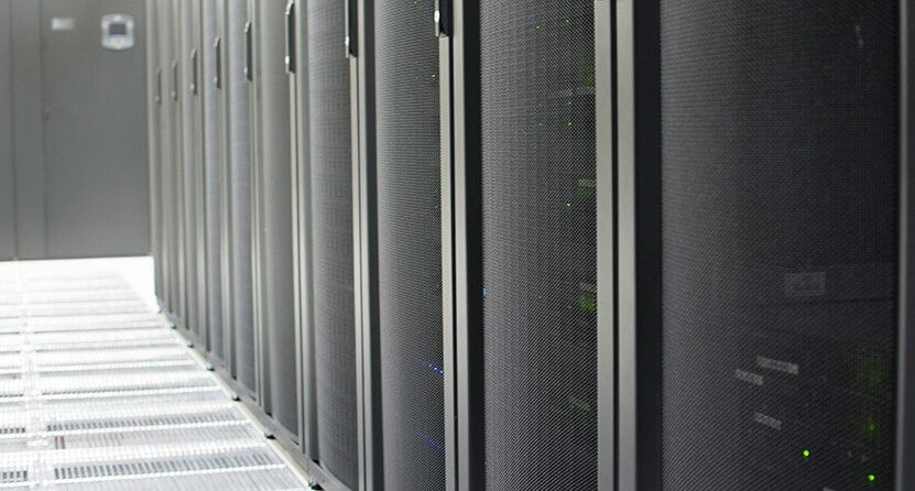 An Opus Interactive blog post image about Colocation, the image is of a server room showing some server cages.