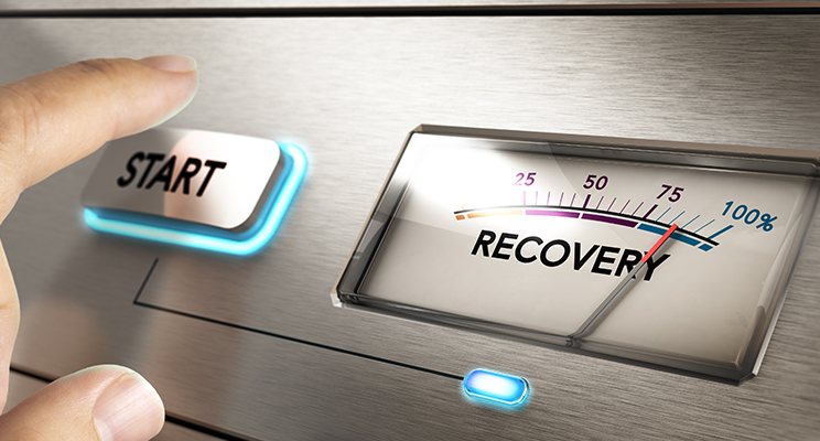 An Opus Interactive blog post image about Business continuity strategy, the image depicts a hand about to press a start button with a scale labeled, "Recovery".