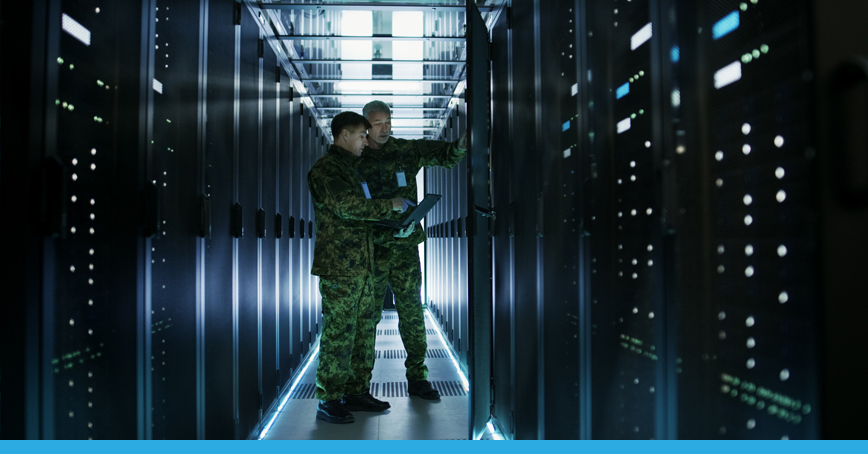 A blog post image depicting two men in military outfits performing maintenance in a server room.
