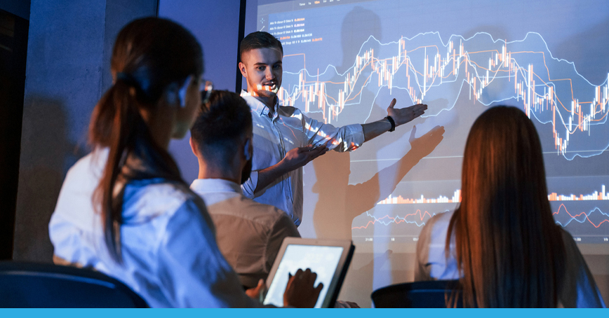 A blog post image depicting a male technician presenting analytics to a team of workers.