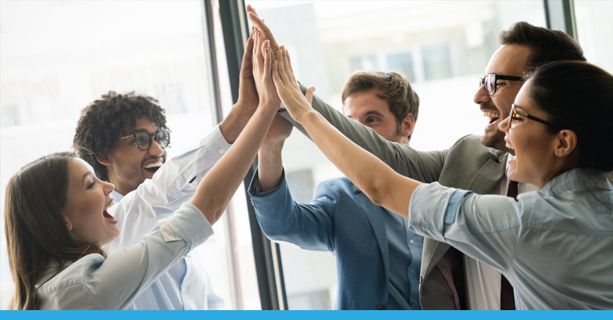 A Blog Post Image featuring a team of businesspeople high-fiving and smiling; seemingly having come to an agreement.