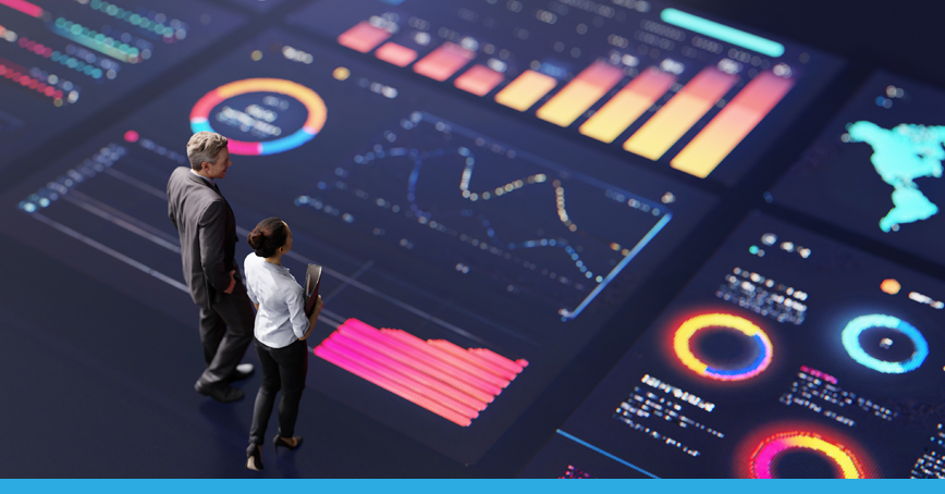 A blog post image depicting a businessman and woman standing together over a giant screen depicting various analytics, indicating a rate of growth and strategizing.