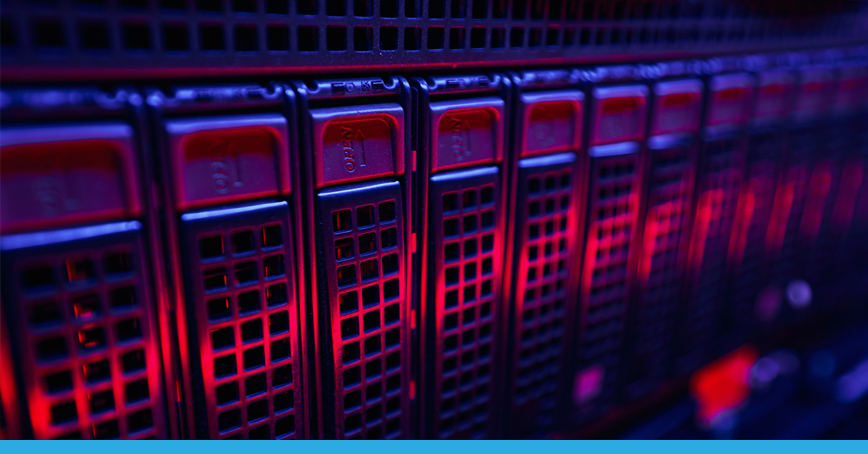 A blog post image depicting a closeup of a server-rack illuminated by blue and red lights.